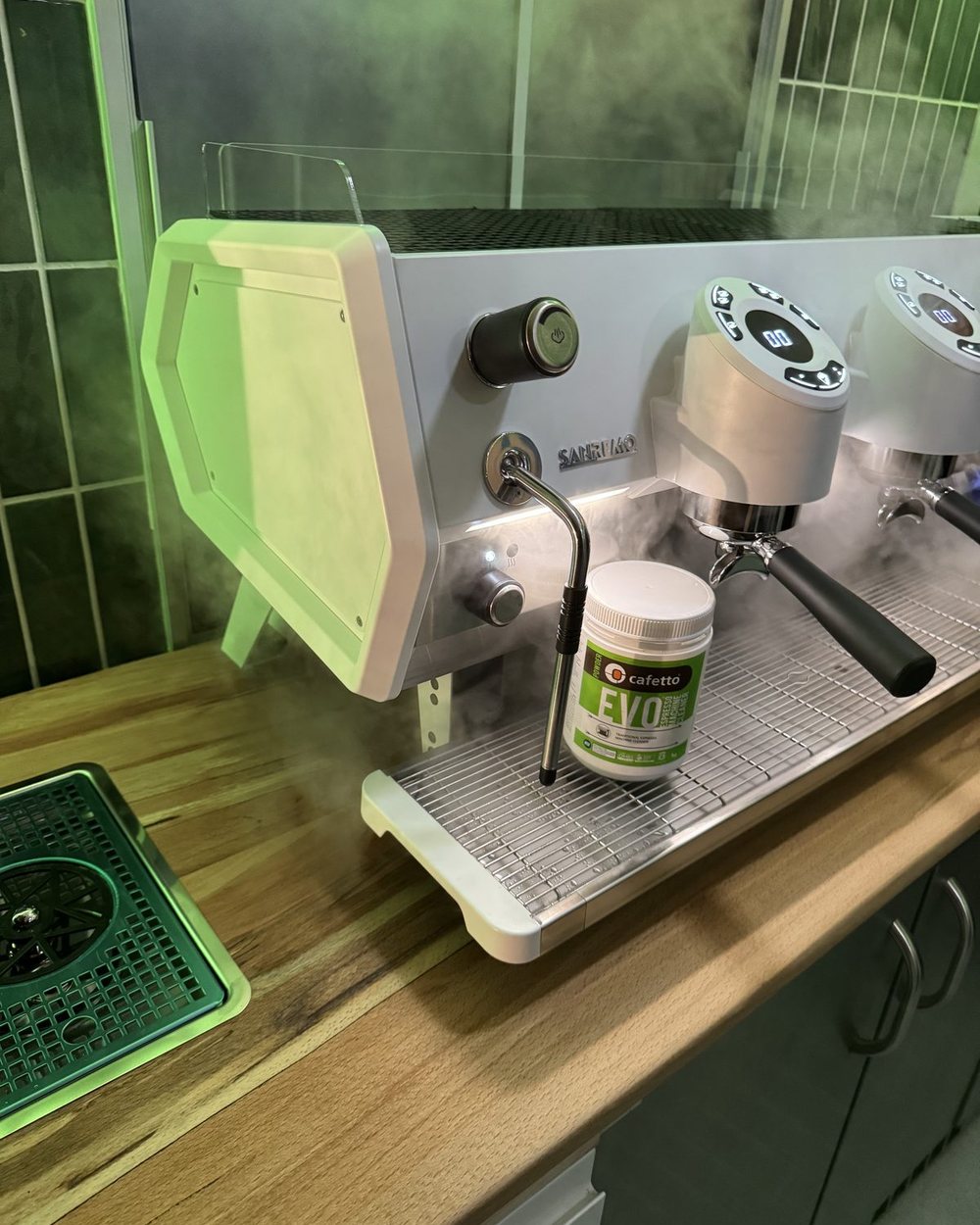 A commercial espresso machine on a timber counter inside a Naked Berry unit